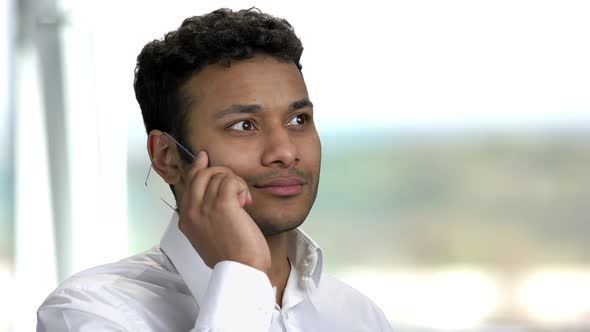 Cheerful Indian Man Talking on Futuristic Transparent Phone.