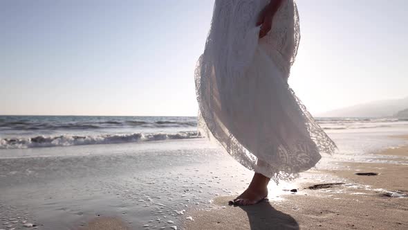 Pregnant Asian woman enjoying walk on the beach