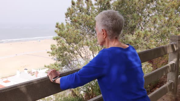 Senior woman exercising at a park by the beach