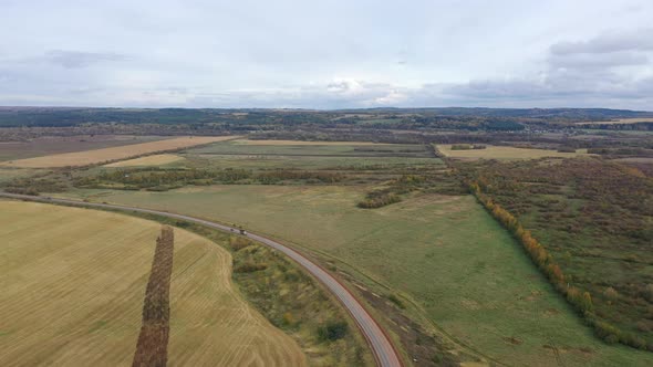 Aerial Drone View Agriculture Crops Wheat Filed with Road and Cars, Highway Road Through Field and