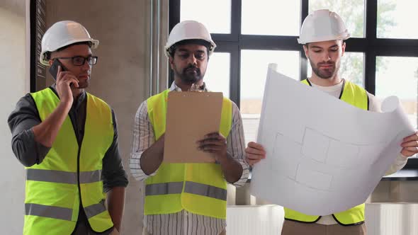 Male Architects in Helmets Working at Office