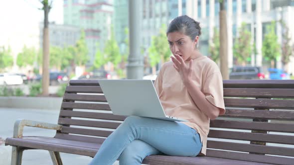 Indian Woman Reacting to Loss While Using Laptop