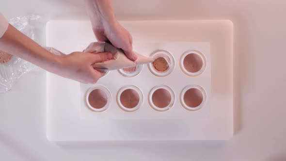 Pastry Chef Pours Mousse Cream Into a Silicone Cake Pan