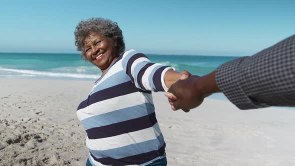 Senior couple holding hands at the beach