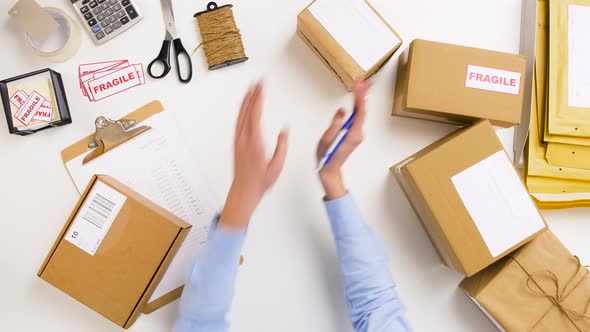 Woman Signing Parcel Boxes at Post Office 6