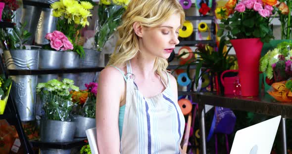 Female florist using laptop in florist shop