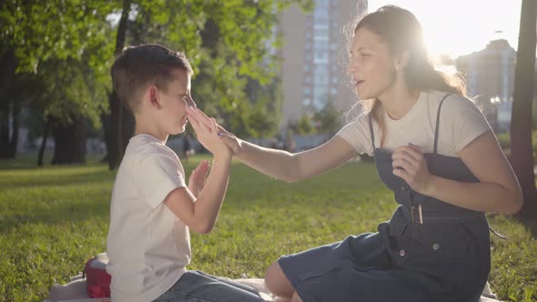 Older Sister Spending Time with Younger Brother Outdoors