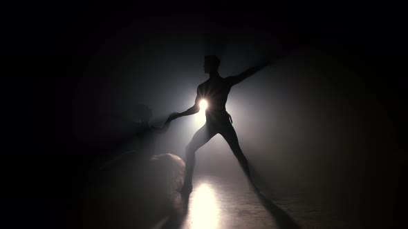 Professional Ballet Couple Dancing in Spotlights Smoke on Big Stage.