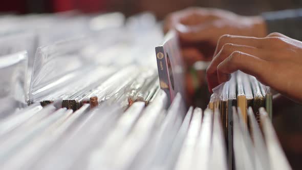 A Young Man eagerly browses through a selection of vintage records