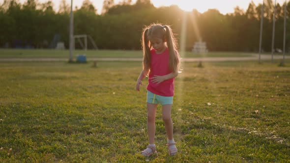 Blonde Little Girl Waves Off Biting Insects at Stadium