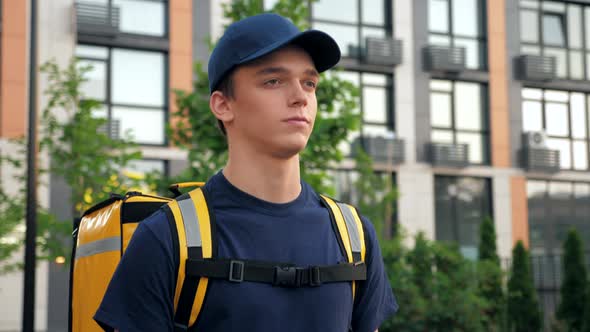 Close Up Delivery Man Courier with Thermal Backpack Walks Street Deliver Order
