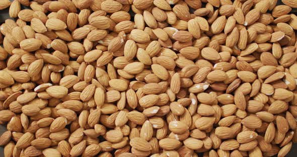 Video of almonds on wooden background