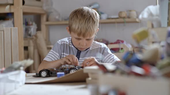 Boy Fixing Toy Car