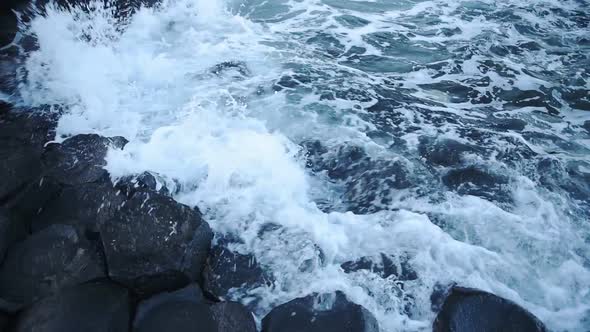 Waves crashing on hexagon geological formations of Giant Causeway coastline, northern Ireland