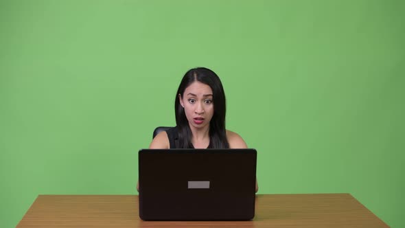 Young Beautiful Asian Businesswoman Using Laptop