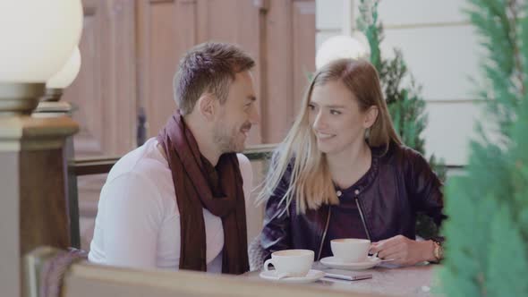 Romantic Couple Drinking Coffee On Date At Street Cafe