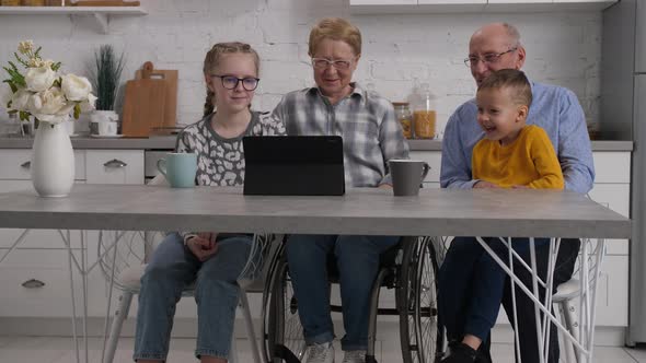 Old and Young Generation Watching Video on Tablet