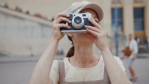 Young tourist taking photo on retro camera