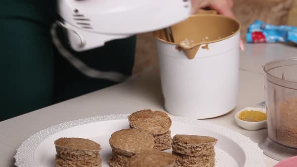 Woman Makes Butter Cream. For A Biscuit Cake With Biscuit Crumbs. Overall Plan