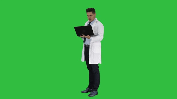 Doctor showing results in laptop on a Green Screen, Chroma Key