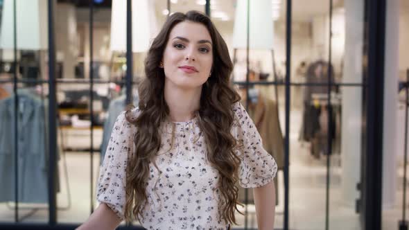 Video portrait of beautiful woman with shopping bags in mall. Shot with RED helium camera in 8K. 