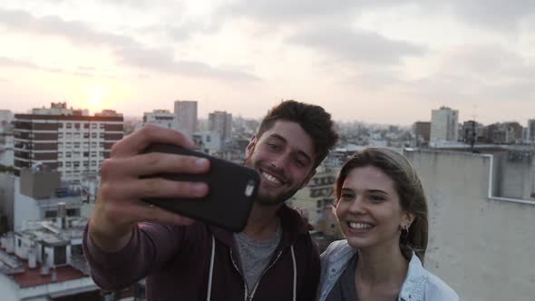 Young couple taking selfie with smartphone