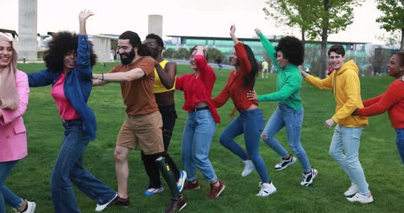 Group of multiracial people dancing together outdoor - Concept of diversity