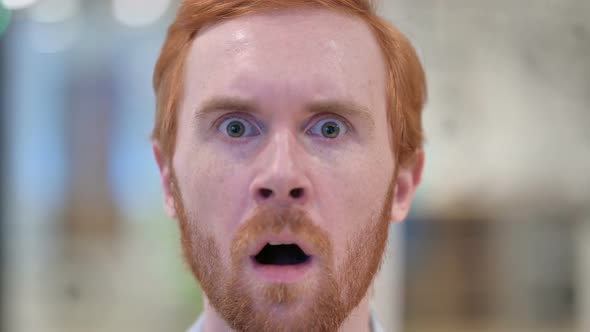 Close Up of Face of Redhead Man Feeling Shocked at Camera 