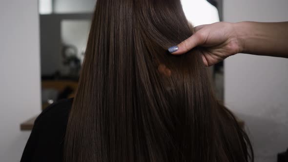 Demonstration of Smooth and Silky Hair After Straightening It with a Steampod