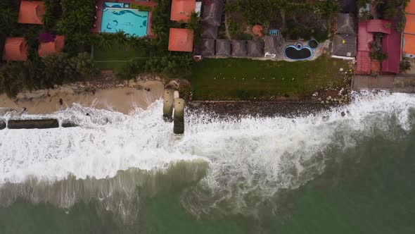 Birdseye aerial dolly right shot of sea that invaded Vietnamese beach