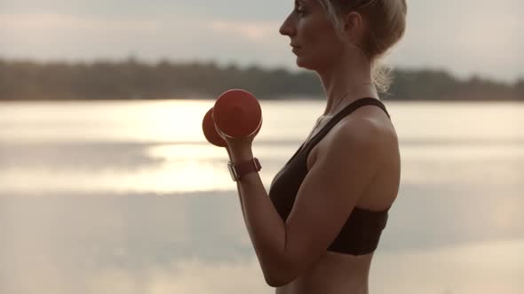 Female In Sportswear Fitness  Exercising Dumbbells Lifting Weights.Sportswoman Doing Sport Exercises