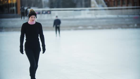 Ice Skating  Young Woman Walks Out on the Ice Rink