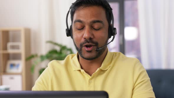 Indian Man with Headset and Laptop Working at Home