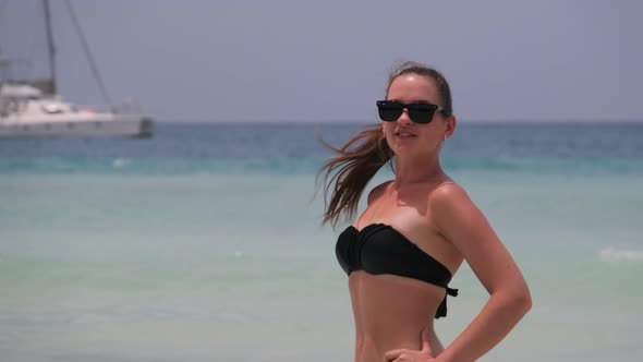 Young Woman in a Bikini Posing on Exotic Beach at the Turquoise Ocean Zanzibar