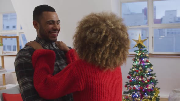 Millennial adult friends celebrating Christmas together at home