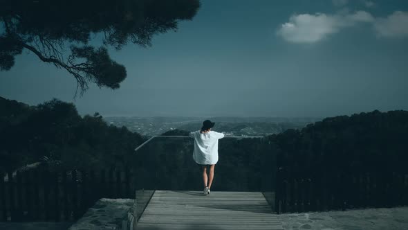 Aerial View Woman on Viewpoint Looking at Green Forest Mountain Landscape View From Back