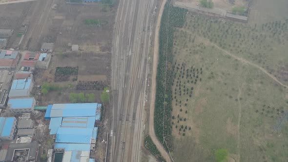 Rural poor village outside Beijing with farmland and train tracks during extreme pollution day