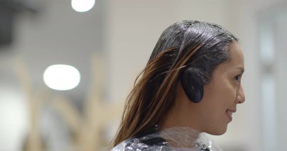 Woman with hair color dye at salon