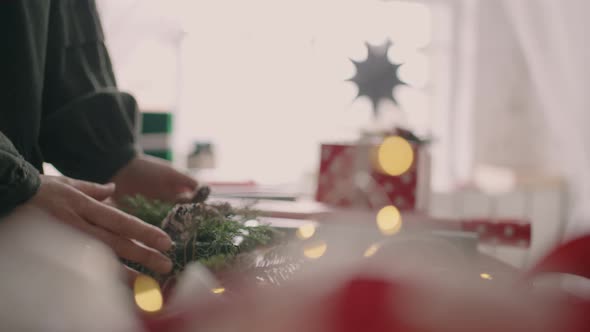 The Hands of a Young Woman Move a Packaged Gift on the Table and Pass It to the Buyer