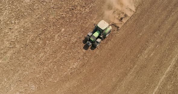 Aerial view of a tractor ploughing an empty field, Kibbutz saar, Israel.