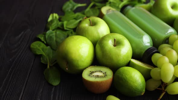 Mixed Green Fruits and Vegetables Placed on Black Wooden Table