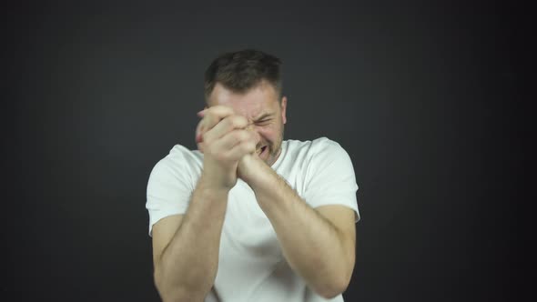 Man with Three-day Beard in T-shirt Laughs Shaking Hands