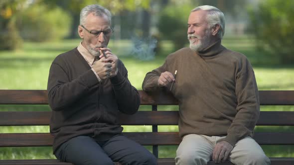 Two Senior Buddies Lighting Cigars