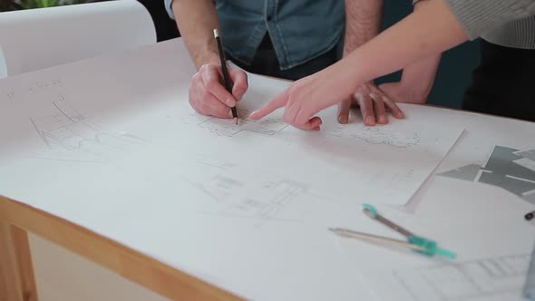 Close Up Hands of Two Workers Discussing Building Drawings in Office, Closeup Shooting of Arms