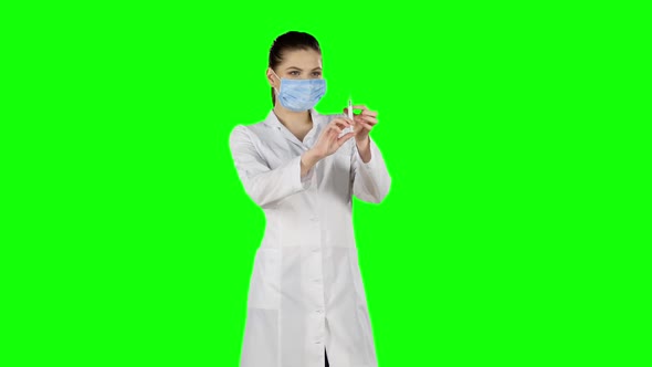 Syringe with a Medicine in a Hand. Green Screen