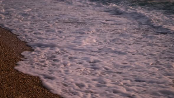 Sea shore with pebbles. Seascape in summer time. Beach and water. Mediterranean sea.