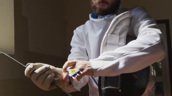 Fencer athlete during a fencing training in a gym