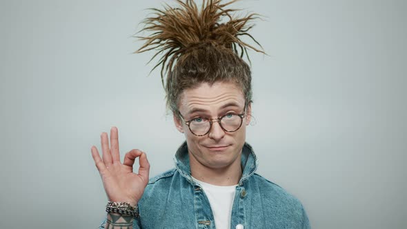 Man Showing Ok Sign with Hand in Studio. Happy Guy Showing Okay Gesture