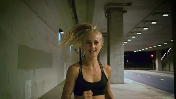 Attractive Woman Jogging Through A Tunnel