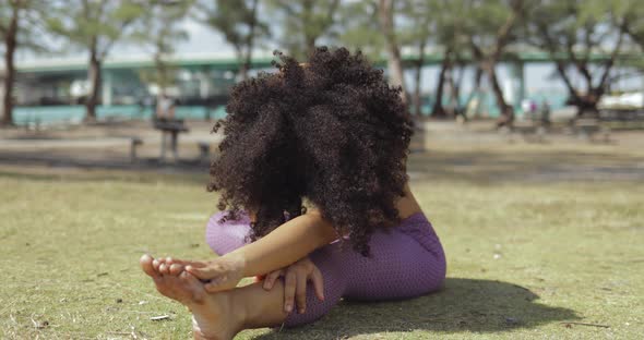 Concentrated Young Girl Stretching Body on Lawn